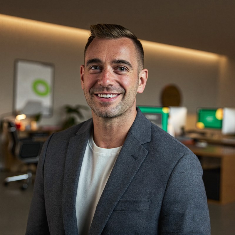 White man in a grey blazer, business casual founder