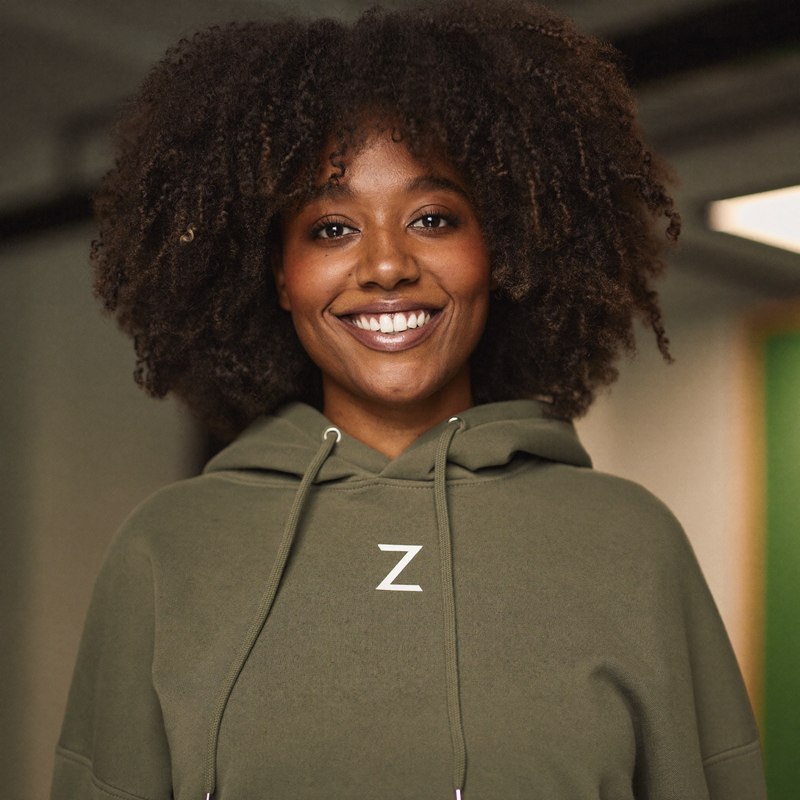 Black woman in a casual hoodie, founder