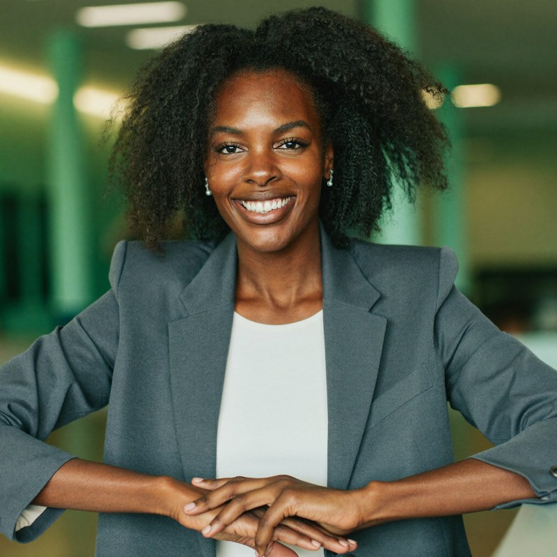 Black woman in a business casual blazer, founder