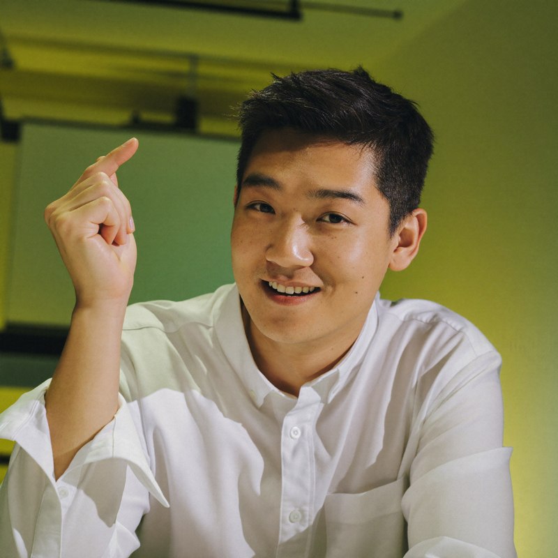 East Asian man in smart casual, founder