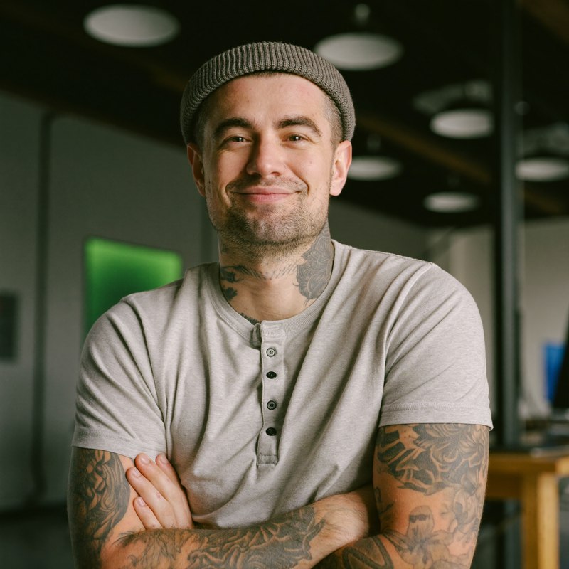 White man in a beanie with visible tattoos, founder