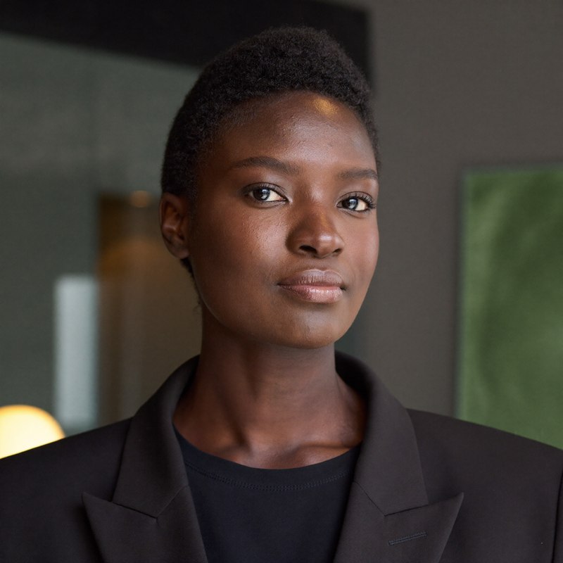 Black woman in a professional blazer, founder