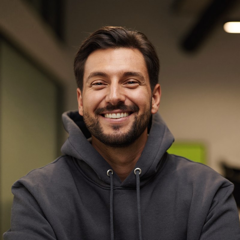 Middle Eastern man with a beard in a casual hoodie, founder